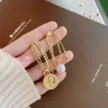 Elegant gold plated fringe drop earrings featuring faux pearl and vintage coin pendants - Portrait Coin Tassel Style (E1536)
