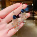 Elegant gold-tone dangling earrings featuring deep blue crystals and tassel details - Blue Crystal Long Tassel Style (E1199)