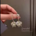 Elegant silver-toned bowknot drop earrings featuring lustrous pearl and rhinestones - Rhinestone Bowknot Pearl Style (E1671) / Silver (E1671)