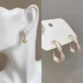 Elegant twisted hoop earrings with white enamel finish in gold-toned metal - Gold and White Spliced Twisted Circle Style (E1737 White)