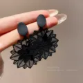 Elegant matte black hollow floral drop earrings featuring a delicate cutout sun pattern - Matte Black Hollow Floral Style (E1726)