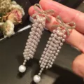 Elegant bow earrings with long pearl tassels and sparkling rhinestone accents. - Bowknot Pearl Tassel Style (E1644)