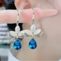 Detail view of blue water-drop earrings featuring elegant cat-eye stone petals and crystals. - Dark Blue Water Drop Floral Earrings (E2561 Blue)