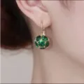 Close-up of elegant gold earrings with faceted green crystal sphere - Faceted Ball Style (E2555) / Green