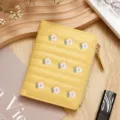 Compact yellow women's wallet with delicate floral embroidery and secure zipper closure. - Yellow
