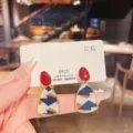 Detailed view of geometric drop earrings featuring patterned fabric and vibrant red stud - Geometric Triangle Fabric Patchwork Style (E2030)