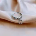 Close-up of minimalist silver adjustable ring featuring a dangling smiley face charm. - Double Layer Round Tag Smiley Style (J0033) / Adjustable Open