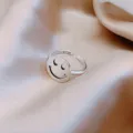 Macro detail of a minimalist silver smiley face ring with S925 engraving on silk fabric - Hollow Smiley Style (J0034) / Adjustable Open