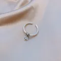 Detailed macro shot of a minimalist silver open ring with a dangling smiley face charm. - Round Tag Smiley Pendant Style (J0035) / Adjustable Open