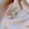 Close-up of a minimalist silver wave textured open ring presented on soft satin fabric - Wave Segmented Texture Style (J0037) / Adjustable Open