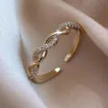 Elegant gold twisted open ring with sparkling cubic zirconia accents on silk background - Twist Knit Style (J0001) / Adjustable Open