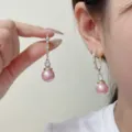 Elegant Korean-style pink pearl drop earrings with sparkling zircon accents on ear - Pink Pearl Zirconia Style (E1734)