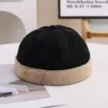 Detailed view of a vintage black and khaki brimless landlord miki hat on a white table - 55-58cm / Color Block Style / Black