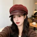 Detailed shot of a stylish burgundy retro newsboy cap with PU leather brim on a model - Adult 55-58cm / Suede Wine Red