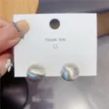 Macro view of minimalist brushed matte silver dome stud earrings displayed on white card - Brushed Matte Hemisphere Stud Earrings (E2609 Silver)