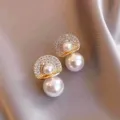 Detailed close-up of elegant gold pearl stud earrings with sparkling rhinestone pavé - Fan Shape Pearl Stud Earrings (E2522 Gold)