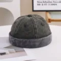 Close-up detail of a vintage washed charcoal grey brimless docker cap with distressed texture - 55-58cm / Color Block Style / Green