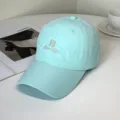Fashionable mint blue baseball cap with Brooklyn embroidery shown from a side angle - Brooklyn Style / Adult 55-58cm / Light Green