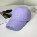 Close-up detail of a purple quick-dry baseball cap with white Brooklyn embroidery. - Brooklyn Style / Adult 55-58cm / Purple