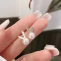 Macro detail view of elegant rabbit-shaped pearl stud earrings with crystal accents - Cute Rabbit Style (E2724 Gold) / Gold