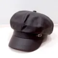 Detailed close-up view of a vintage dark brown PU leather newsboy hat with a metal buckle - Adult 55-58cm / Leather Coffee
