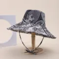 Detailed view of the intricate paisley and floral print on a wide-brim sun hat - Adult 55-58cm / Black and White Paisley Print (3)