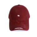 Closeup of a maroon baseball cap featuring white NB embroidery and brim text detail. - Adult 56-60cm / NB Wine Red
