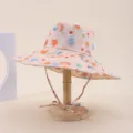 Wide-brimmed sun hat with colorful abstract print, chin strap, and wooden stand detail - Adult 55-58cm / Beige Abstract Gradient Polka Dot Print (27)