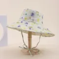 Detail view of a wide brim sun hat with colorful watercolor floral print on a wooden stand - Adult 55-58cm / Off-White Abstract Watercolor Polka Dot Print (28)
