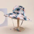 Macro view of abstract watercolor print and adjustable chin strap on foldable wide brim sun hat - Adult 55-58cm / Blue Orange White Abstract Ink Wash Print (29)