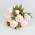 Detailed close-up view of artificial pink peony flower bouquet showing delicate fabric petal texture. - Champagne