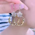 Detail shot of gold-finish flower earrings with sparkling crystals and faceted beads. - Hook Floral Tassel Style (E2486) / Gold