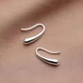 Elegant minimalist silver teardrop hook earrings displayed on textured brown fabric background - Minimalist Teardrop Hook Style (E3101) / Silver