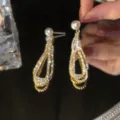 Elegant vintage gold teardrop earrings encrusted with crystals and a white pearl accent - Hollow Teardrop Pearl Style (E3016) / Gold
