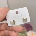 Elegant gold butterfly stud earrings with sparkling rhinestones on white display card - Full Rhinestone Butterfly Stud Style (E2344 Gold Stud) / E2344 Gold Stud
