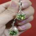 Elegant silver drop earrings featuring vibrant green faceted gemstones in a variant view - Sunflower Silver Green Earrings (E2524 Silver Green)