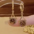 Elegant gold-tone lever-back earrings with large round champagne gemstones - Round Rhinestone Border Drop Earrings (E2524) / Champagne