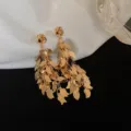 Elegant vintage gold leaf tassel dangling earrings with a glossy metallic finish - Twisted Leaf Tassel Style (E3038) / Gold