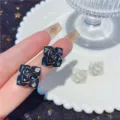 Elegant flower stud earrings with shimmering shell texture in black and white finish - Black-Edged 3D Flower Style (E2375) / Gold + Black (E2375)