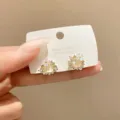 Elegant floral stud earrings featuring shimmering crystals and premium 925 silver posts. - Pearly Rhinestone Flower Style (E2377) / Gold (E2377)