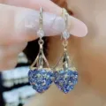 Elegant 18k gold plated heart drop earrings featuring sparkling light blue crystal pavé accents - Heart-Shaped Crystal Drop Earrings (E2537 Blue/White)