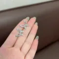 Elegant silver butterfly ear studs with sparkling rhinestones and hollow wing design for women - Hollow Butterfly Style (E2409) / Silver
