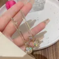 Elegant gold long drop earrings with delicate rhinestone tassels and sparkling crystal balls - Hollow Ball Tassel Drop Earrings (E1382) / Gold