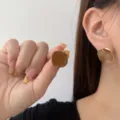 Vintage style caramel square stud earrings with elegant gold edges shown on model - Irregular Square Enamel Style (E3554 Gold Khaki) / Gold Khaki