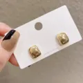 Minimalist gold-tone square stud earrings on a white display card, smooth polished finish. - Minimalist Mirror Surface Square Studs (E1348) / Gold