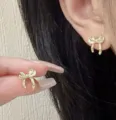 Elegant vintage-style golden bow-knot stud earrings featuring a minimalist textured design - Vintage Bowknot Stud Earrings (E4686) / Gold