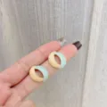 Retro oval enamel stud earrings with mint green and peach marble finish on fingers - Oval Hollow Two-Tone Enamel Stud Earrings (E2763 Gold)