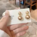 Elegant champagne double pearl earrings for women shown on a white display card - Double Pearls Style / Champagne Gold (E3237)