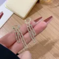 Elegant gold geometric dangle earrings with sparkling rhinestones in a modern luxury style. - Overlapping Rectangle Pave Style (E3196) / Gold