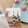 Elegant gold-tone rhombus drop earrings with black stones and sparkling rhinestones. - Tiered Rhombus with Black Stone Style (E3161) / Gold Black